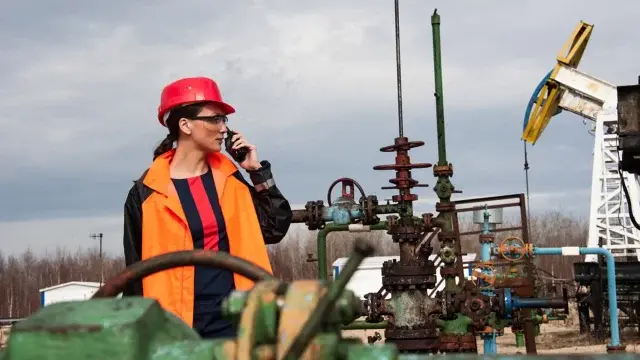 female engineer on walkie talkie in work field